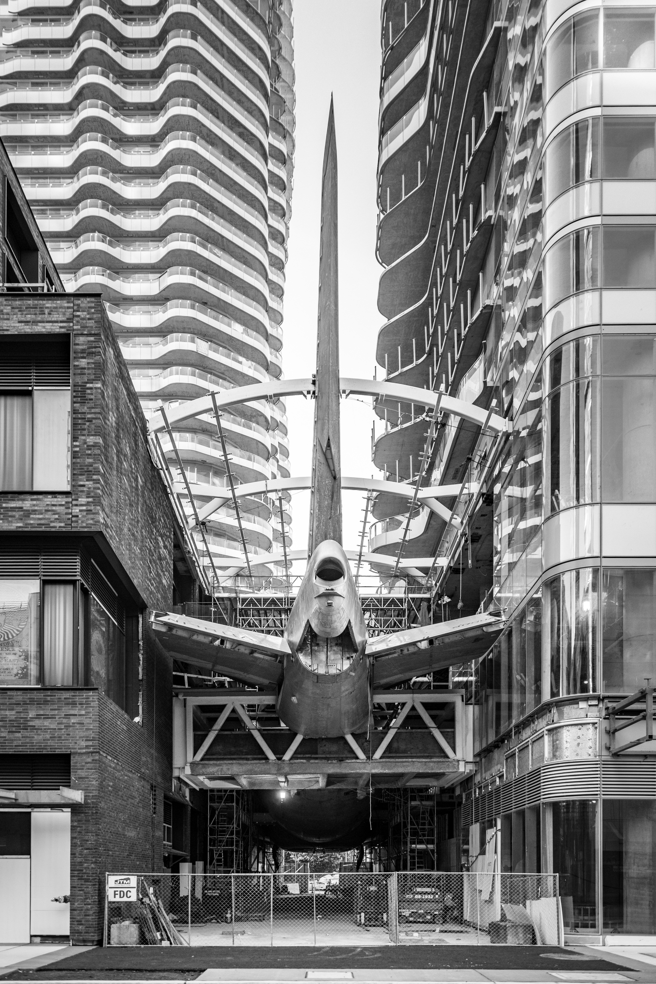 Rear view of the same Boeing 747 fuselage and its upright tail between AERO1200's two towers during construction.